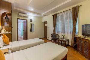Uma cama ou camas num quarto em Dahlia Boutique Hotel