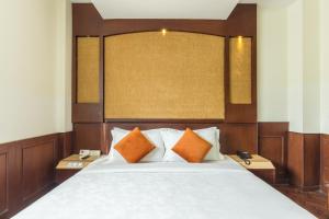 Uma cama ou camas num quarto em Dahlia Boutique Hotel