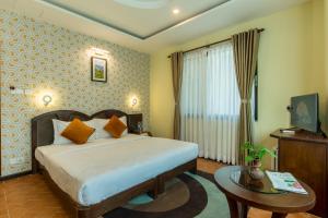 Uma cama ou camas num quarto em Dahlia Boutique Hotel
