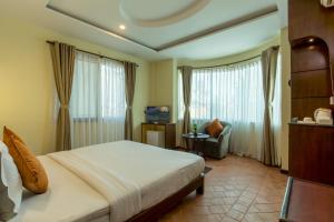 Uma cama ou camas num quarto em Dahlia Boutique Hotel