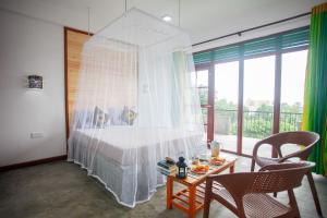 Cama ou camas em um quarto em Ella Rawana Den Hotel