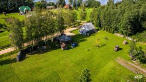 an aerial view of a field with a group of tents at Pērkonu namiņš in Balvi +37 photos
