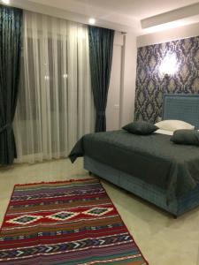 a bedroom with a bed and a rug at The Cotton House Hotel in Pamukkale