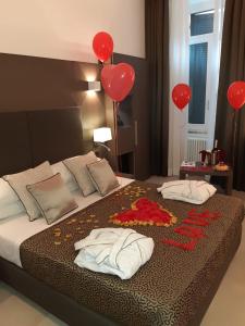 a bedroom with red balloons and a bed with two pillows at Wellness Home Rome in Rome