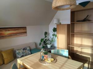 a dining room with a table and a couch at Hotel-Pension Seeadler in Prerow