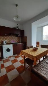 a living room with a table and a kitchen at Apartment Na Saharova in Ivano-Frankivsk +8 photos