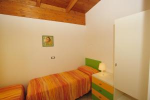 a bedroom with a bed and a dresser in a room at Camping Terrazzo sul mare in Cupra Marittima