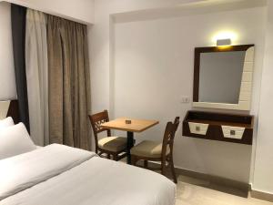 Voodi või voodid majutusasutuse Maxim Hotel toas