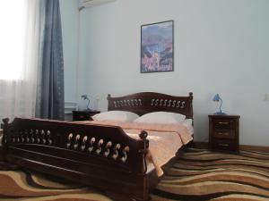 a bedroom with a bed and a rug at Hotel Kuzbass in Shakhty