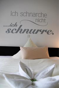 a bedroom with a bed with a white flower on it at NOX - Bed & Breakfast in Steinheim