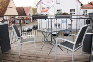 a glass table and two chairs on a balcony at NOX - Bed & Breakfast in Steinheim