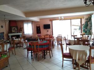 a dining room filled with tables and chairs at To Spiti tis Irinis in Vitina