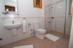 a bathroom with a toilet and a sink and a shower at Lycia Hotel in Kaş