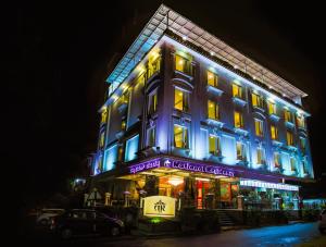 a building with blue lights on it at night at National Residency in Mysore