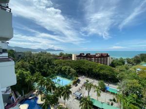 a view of the pool at a resort at The View Feringghi Executive Apartment in Batu Ferringhi