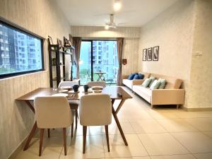 a living room with a table and chairs and a couch at The Lakes at Midhills Genting in Genting Highlands