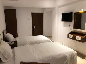 Voodi või voodid majutusasutuse Maxim Hotel toas