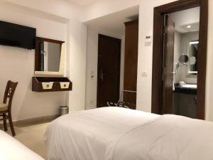 Voodi või voodid majutusasutuse Maxim Hotel toas