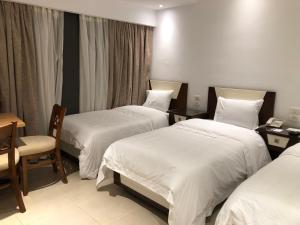Voodi või voodid majutusasutuse Maxim Hotel toas