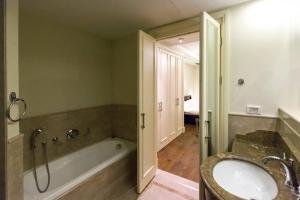 a bathroom with a bath tub and a sink at SUITE WA B1 - WALDORF ASTORIA RESIDENCES - JERUSALEM-RENT in Jerusalem