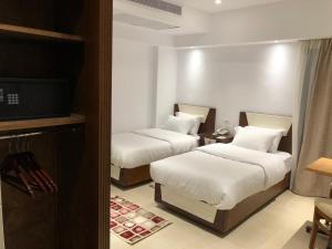 Voodi või voodid majutusasutuse Maxim Hotel toas