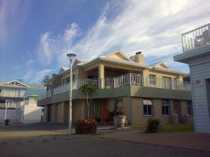 a large house with a balcony on top of it at 2 Geckos in Mossel Bay