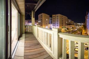 a balcony with a view of a city at night at SUITES WA B1+B2 - WALDORF ASTORIA RESIDENCES - JERUSALEM-RENT in Jerusalem