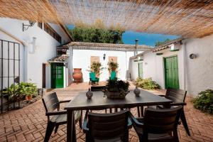 an outdoor patio with a wooden table and chairs at Cauchil Chico in Alcalá la Real