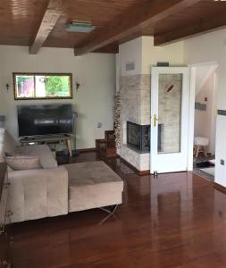 a living room with a couch and a fireplace at Holiday Home Magnolia in Trakošćan
