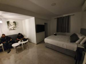 two men sitting on a couch in a hotel room at The boutique in Jerusalem