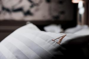 a piece of paper sitting on top of a bed at Boutique Hotel Arbat 6 in Moscow