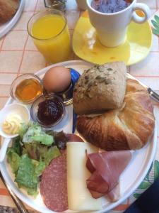 a plate of food with bread and meats and a cup of coffee at A Hotel Yerevan in Yerevan