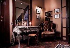 a room with a table and a chair and a mirror at Boutique Hotel Arbat 6 in Moscow