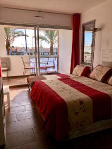 a bedroom with a bed with a view of a balcony at Cap Capistol Studio le Cap d'Agde vue port in Cap d'Agde