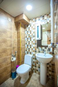 a bathroom with a toilet and a sink at Apartments Beautiful Tbilisi on L.Meskhishvili Turn 1 in Tbilisi City +16 photos