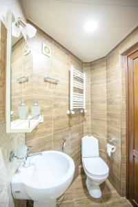 y baño con aseo blanco y lavamanos. en Apartment on L.Meskhishvili Turn, en Tiflis