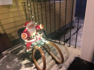 a santa claus hanging from a swing in the snow at Sälengården in Vörderås