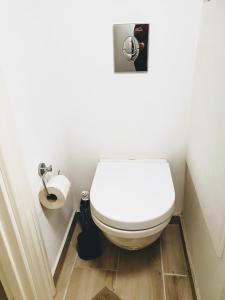 a bathroom with a toilet and a toilet paper roll at Koege Guesthouse in Køge