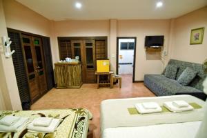 a living room with two beds and a couch at Phu Mork Dao Resort in Pong Yaeng