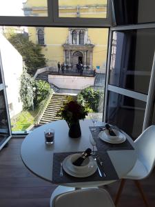 a table and chairs with a view of a building at ZAGRABY APARTMENT in Zagreb