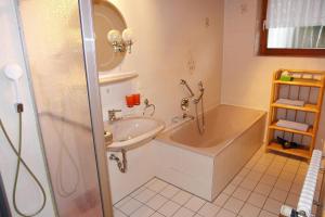 a bathroom with a tub and a sink and a shower at Schwarzwälder Ferienwohnungen in Seelbach +44 photos
