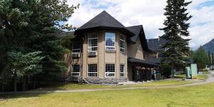 a large house with a black roof at Mountain View Inn in Canmore