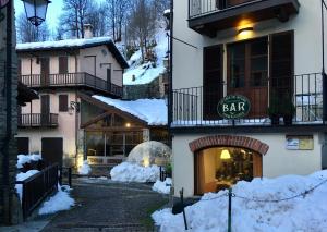 a building with snow on the side of it at Locanda Del Mulino in Pamparato