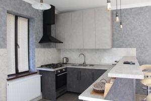 a kitchen with a sink and a stove top oven at Green Apartment in Kazbegi