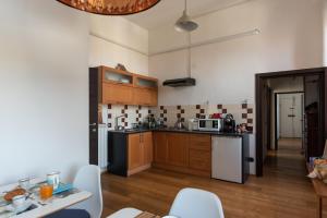 a kitchen with wooden cabinets and stainless steel appliances at Da Linda in Livorno
