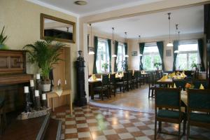 a dining room with tables and chairs in a restaurant at Hotel-Gasthof Eberherr in Forstinning