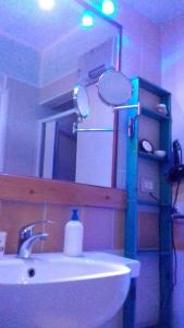 a bathroom with a sink and a mirror at La Casa di Ulisse B&B in Quercianella