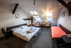 a bedroom with a bed and a table and chairs at Hotel Pyramida in Brno