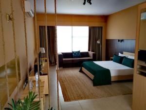 um quarto de hotel com uma cama e um sofá em RT Palmela Village em Palmela