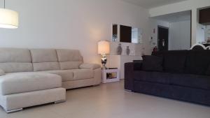 a living room with two couches and a couch at Cavalo Preto Luxury Beach Resort in Quarteira